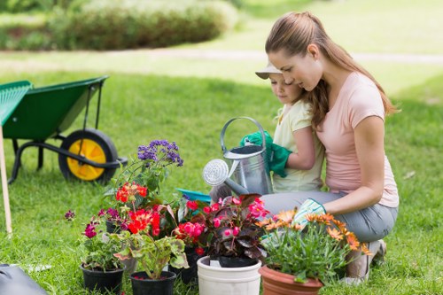 Gardener assisting a customer with service details in a garden
