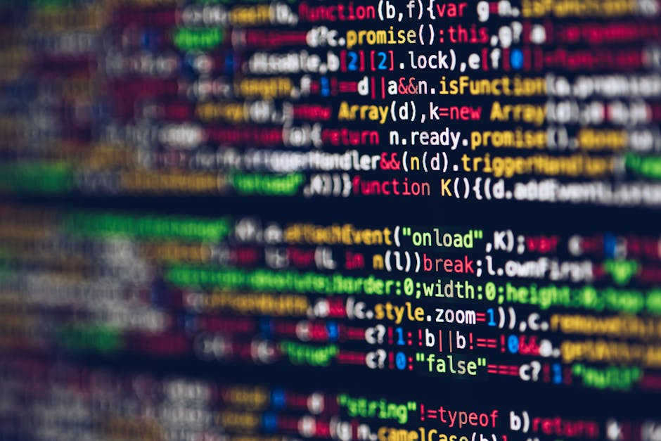 A close-up image of a computer screen displaying colorful lines of programming code in different colors such as red, green, yellow, blue, and white on a dark background. The text includes various synt